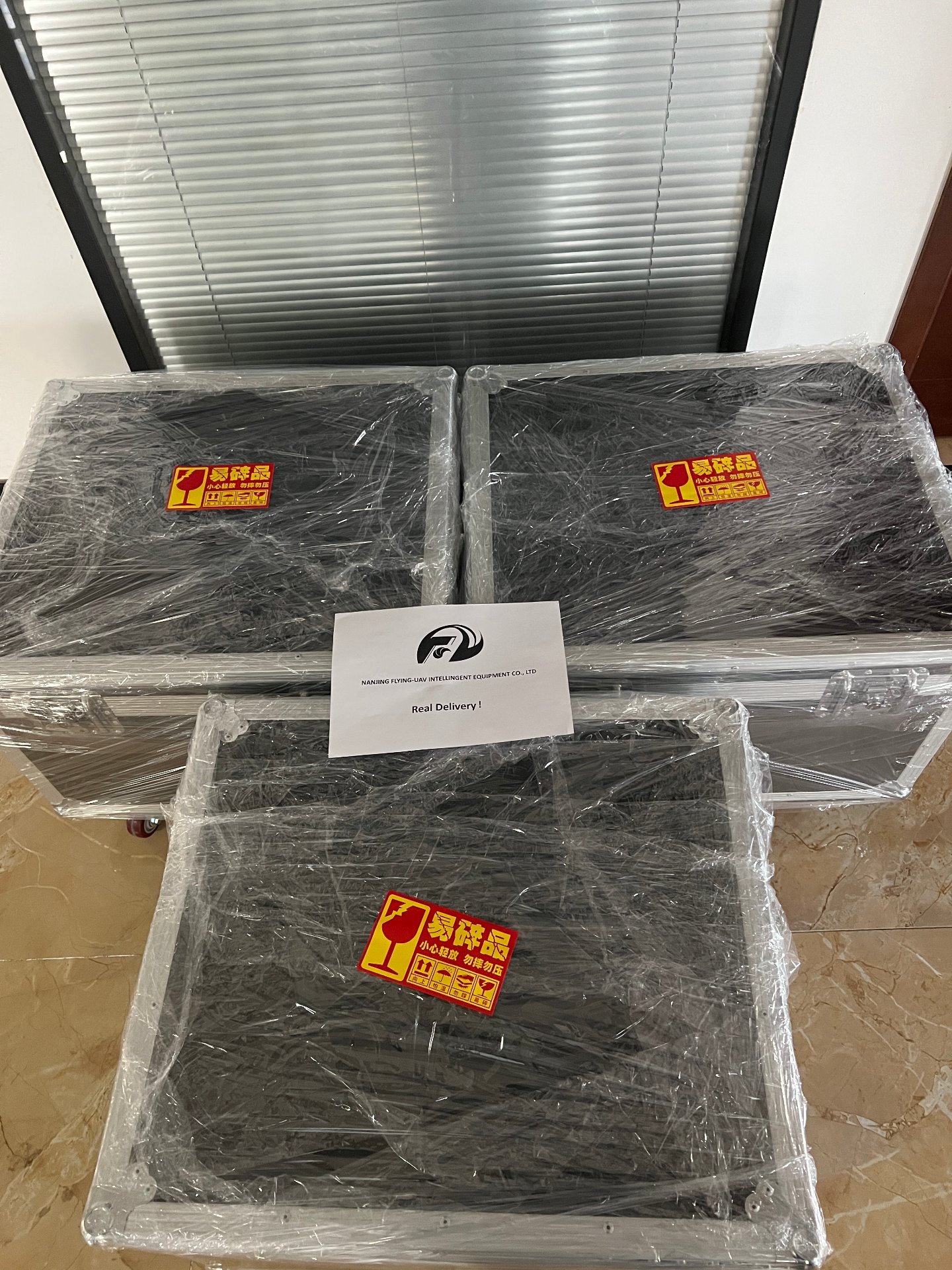 Reinforced export cases wrapped and fragile-labeled, ready for international shipping